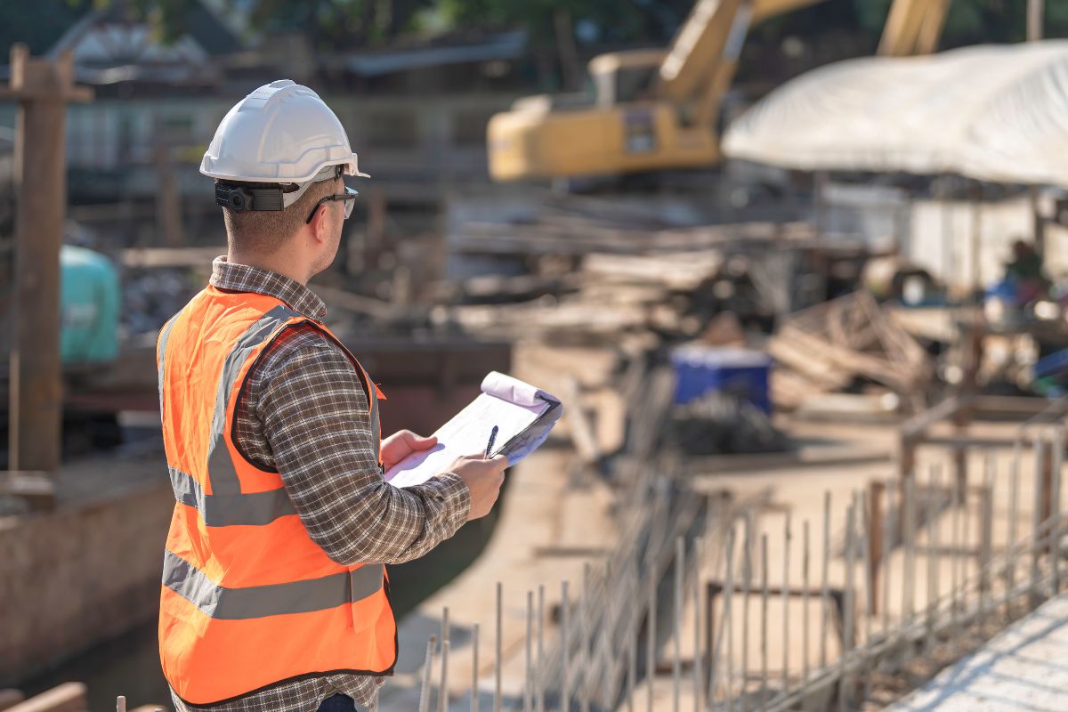 Obra de pavimentación con maquinaria y operario aplicando mecánica de suelos y diseño de pavimentos